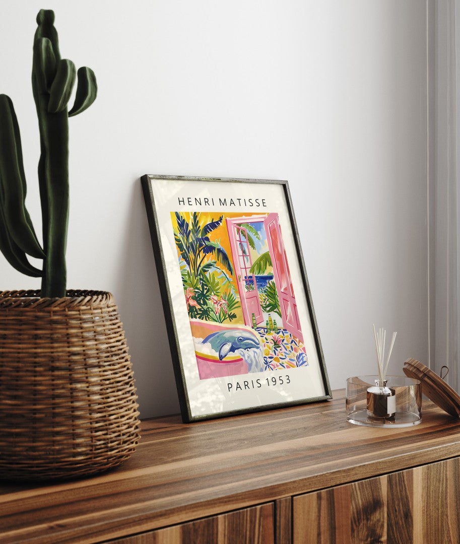 Framed print of a bathing whale in a bright, plant-filled room opening to the sea, inspired by Henri Matisse.